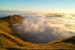 Sonnenaufgang mit Bodennebel im Tuki Tuki Valley, dramatische Nebelzungen zwischen brauner Hügellandschaft, Weideland, Nebelmeer, Blick vom Felskamm des Te Mata Peak über das Hinterland, Hügellandschaft der Hawkes Bay, Havelock North, Nordinsel Neuseeland