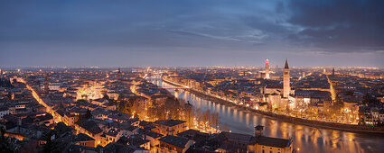 Wide view from Castel San Pietro over the nightly city of Verona with the towers of the church Santa Anastasia (right) and the Torre dei Lamberti (left) on the Adige, Veneto, Italy