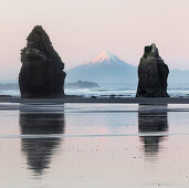 Rock formations and view of Mount Taranaki volcano, Tongaporutu, Taranaki, North Island, New Zealand, Oceania