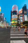 Zebra Crossing with moving women at Ricoh Imaging Square in Ginza during blue hour, Chuo-ku, Tokyo, Japan