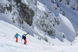 Several persons backcountry skiing ascending towards Manndlkogelscharte, Manndlkogelscharte, Gosau group, Dachstein, UNESCO World Heritage Site Salzkammergut-Dachstein, Salzburg, Austria