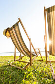 Beach at lake Plauer See, camping ground, willow, sunset, beach chair, swimming, summer, Mecklenburg lakes, Mecklenburg lake district, Zislow, Mecklenburg-West Pomerania, Germany, Europe