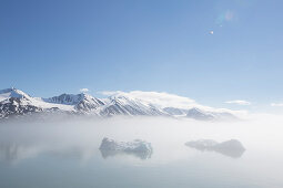 Small icebergs in the mist at Liefdefjorden, Spitzbergen, Svalbard