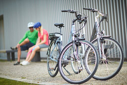 Man and woman having a rest, eBikes, City, Munich, Bavaria, Germany
