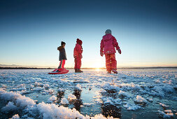 Kids on a frozen Lake Starnberg, Muensing, Upper Bavaria, Bavaria, Germany