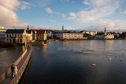 Reykjavíkurtjörn, or Tjörnin lake, with a view to the city, Reykjavik, Iceland, Europe