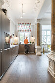 woman in the kitchen of a modern furnished Art Nouveau apartment in Hamburg, north Germany, Europe