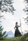 Young woman in traditional costume hiking on the Falkenstein in the Allgaeu, Pfronten, Bavaria, Germany
