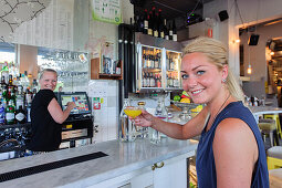 Young woman drinking a drink Pub Urban Deli AB in SOFO, Stockholm, Sweden