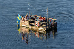 Children jump from the raft at the Skansen open-air museum, Stockholm, Sweden