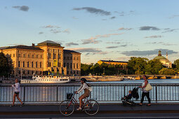 Pedestrian and cyclist in front of National Museum, Stockholm, Sweden