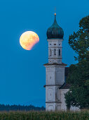 partial lunar eclipse at the St Andreas chapel soth of Weilheim, Bavaria, Germany