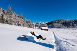 taking a rest after a winterwalk in the fresh snow near Gerold, Bavaria, Germany