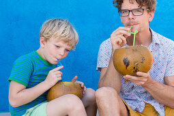 Father and son drinking from a coconut, Playa Larga, family travel to Cuba, parental leave, holiday, time-out, adventure, MR, Playa Larga, bay of pigs, Cuba, Caribbean island