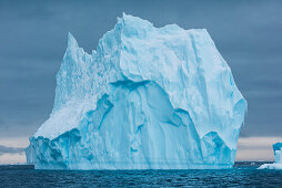 A towering iceberg drifts in the sea, Active Sound, Antarctica