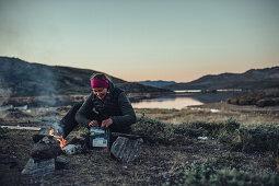 woman cooking an instant meal, greenland, arctic.
