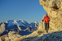 Woman hiking with Marmolada in background, from Lagazuoi, Dolomites, UNESCO World Heritage Site Dolomites, Venetia, Italy