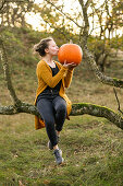 Girl with pumpkin on Halloween, Hamburg, Germany