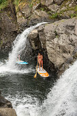 USA, Hawaii, The Big Island, Hilo, paddle boarding on the Wailuku River near the Singing Bridge