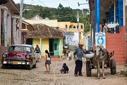Street with cobblestone, man with donkey, kids, Trinidad Cuba