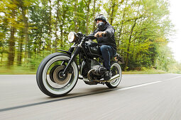 older man riding his motorbike