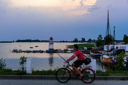 Boy with bike and fishing in Waase village on Ummanz, Ruegen, Baltic Sea coast, Mecklenburg-Vorpommern, Germany