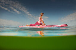 Yoga Teacher on SUP Board,  Lake Starnberg, Bavaria, Germany