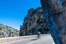 A cyclist on the famous winding road leading to Torrent de Pareis, Sa Calobra, Tramuntana Mountains, Mallorca, Spain