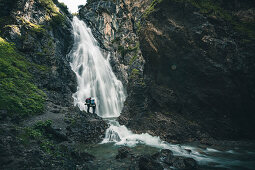 hiker in front of the Simms waterfall, E5, Alpenüberquerung, 2nd stage, Lechtal, Kemptner Hütte  to Memminger Hütte, tyrol, austria, Alps