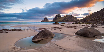 tidal pool in the midnight sun on a sandy beach near the city of Sto, Vesteralen islands, Norway