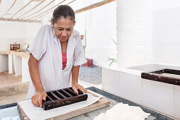 woman working at historical Paper Production at Fundación San Lorenzo, Barichara, Departmento Santander, Colombia, Southamerica