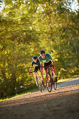 two young men on gravel bikel on a gravel road, Muensing, bavaria, germany