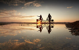 junge Frau auf Tourenrad und junger Mann auf eTourenfahrrad, Radtour am See, Münsing, Starnberger See, Bayern, Deutschland
