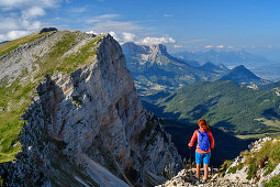 Woman while hiking rises from the Grand Veymont, Grand Veymont, Vercors, Dauphine, Dauphine, Isère, France