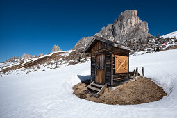 Wooden hut in the snow at the Passo di Giau in winter. Crossing to the spring, Dolomites, Cortina d'Ampezzo, Belluna, Italy