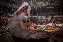 Kyrgyz cooks meat for sacrificial festival, Afghanistan, Asia