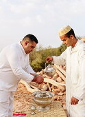 Performing a traditional hand-washing ritual with orange blossom, Morocco