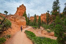 Woman hikes through Bryce Canyon National Park, USA