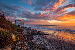 Sunset on the west coast of California beach with lifeguard tower