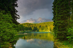 Karersee, natural monument under the rose garden, in the South Tyrolean Dolomites, UNESCO World Natural Heritage, in Eggental, Italy