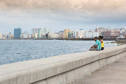 Cubans on the Malecón promenade in Havana, Cuba