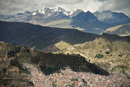 View from El Alto to the extensive urban expanse of La Paz, in the background snow-capped peaks of the Andes, Bolivia, South America