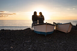 Two women sit on a boat and look out over the Atlantic, El Remo, La Palma, Canary Islands, Spain, Europe