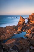 Peniche rocky coast with sea in sunset, Portugal
