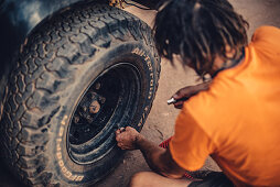 Tire change on a 4x4 off-road vehicle in El Questro Wilderness Park, Kimberley Region, Western Australia, Australia, Oceania;