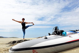 Standing yoga paddler on Luskentyre Beach, Isle of Harris, Outer Hebrides