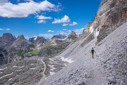 Man hiking below the Paternkofel at the Three Peaks in the Dolomites Nature Park, South Tyrol