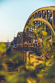 People sit at sunset on the Hackerbruecke in Muenchen, Bavaria, Germany, Europe