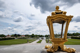 View of the square in front of the Nymphenburg Palace, in the foreground a golden lamp, Munich, Bavaria, Germany, Europe