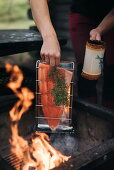 Locally caught salmon cooked over a flame with spruce twigs, Finland